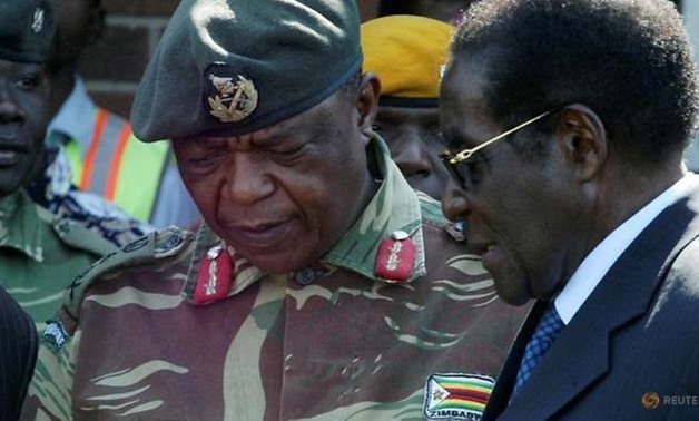  President Robert Mugabe talks to General Constantino Chiwenga in Harare, Zimbabwe, July 4, 2008. REUTERS/Philimon Bulawayo/File Photo