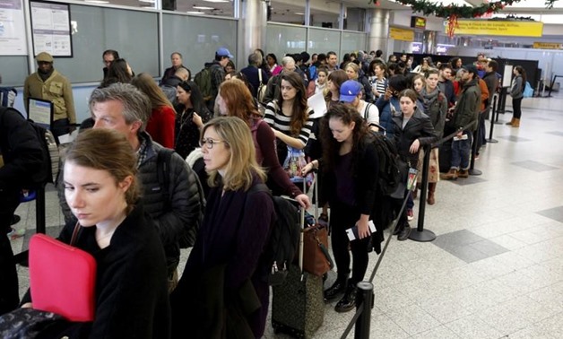 FILE : Travelers wait in line at a security checkpoint at La Guardia Airport in New York November 25, 2015. REUTERS/Brendan McDermid