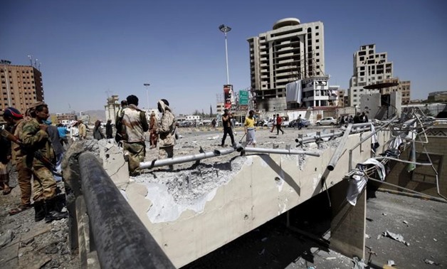 Houthi militants stand at the site of a Saudi-led air strike which targeted a tunnel leading to the presidential house near the Petrol Station in Yemen's capital Sanaa, October 1, 2015. REUTERS/Mohamed al-Sayaghi
