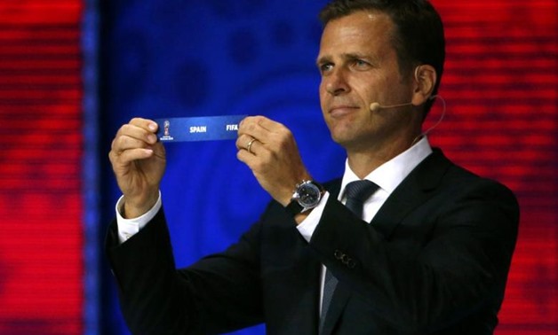 Former German soccer player Oliver Bierhoff holds up the slip showing "Spain" during the preliminary draw for the 2018 FIFA World Cup at Konstantin Palace in St. Petersburg, Russia July 25, 2015. REUTERS/Grigory Dukor