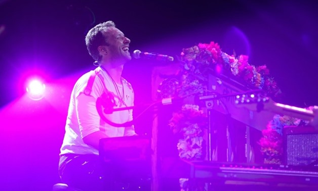 Coldplay frontman Chris Martin, playing a charity concert in Hamburg, Germany last July -AFP