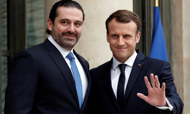French President Emmanuel Macron and Saad al-Hariri, who announced his resignation as Lebanon's prime minister while on a visit to Saudi Arabia, react on the steps of the Elysee Palace in Paris, France, November 18, 2017. REUTERS/Benoit Tessier

