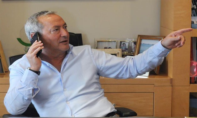 Samih Sawiris, Egyptian billionaire construction tycoon speaks in his mobile phone before an interview with Reuters to discuss his investment plans and outlook for the economy since the flotation of the pound in Cairo, Egypt February 21, 2017. Picture tak