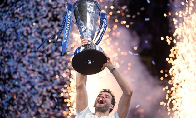 Tennis - ATP World Tour Finals - The O2 Arena, London, Britain - November 19, 2017 Bulgaria's Grigor Dimitrov celebrates with the trophy after winning the final against Belgium's David Goffin REUTERS/Toby Melville