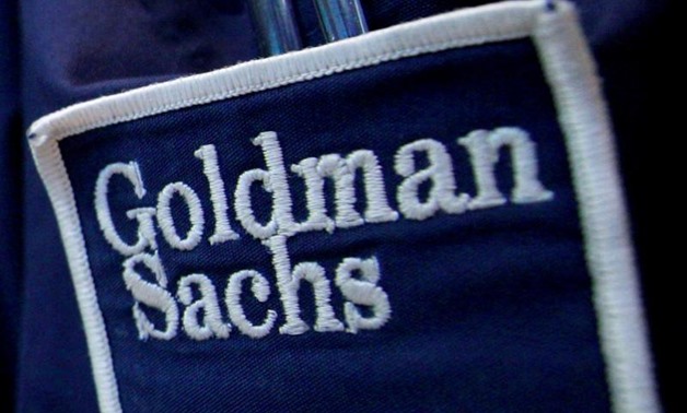 Goldman Sachs (GS) logo is seen on the clothing of a trader working at the Goldman Sachs stall on the floor of the New York Stock Exchange, United States April 16, 2012. REUTERS/Brendan