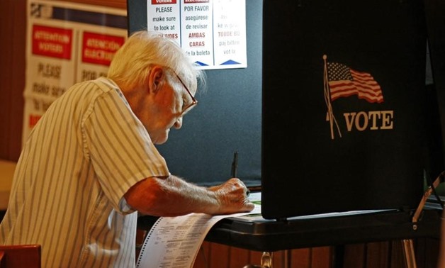  An unidentified voter casts his ballot at a local polling station in Miami November 2, 2010. REUTERS/Hans Deryk