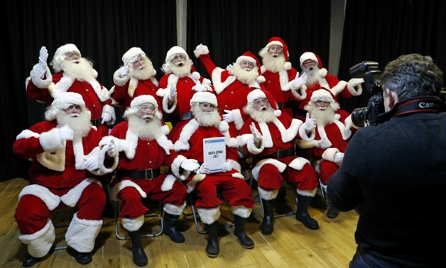 Student Santas pose during a training session at The Ministry of Fun Santa School in London, on November 16, 2017 -AFP