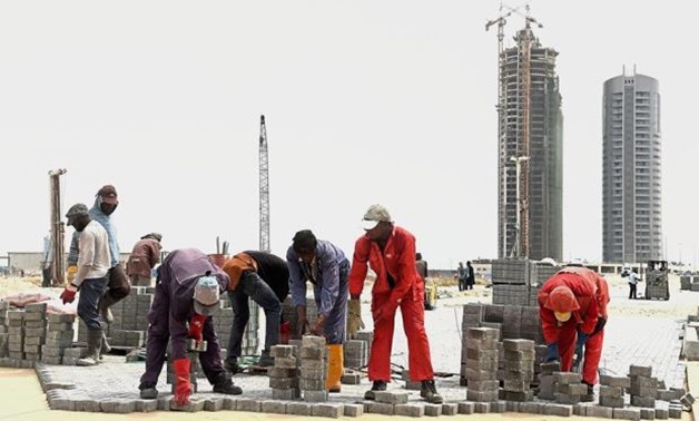 In trouble waters: Workers lay interlocking tiles to build a road in Eko Atlantic City, Lagos. The International Monetary Fund has predicted that Nigeria’s economy would shrink 1.8 in 2016. — AFP