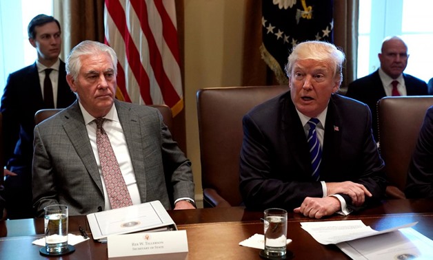 U.S. Secretary of State Rex Tillerson (L) listens to U.S. President Donald Trump speak during a meeting with his Cabinet at the White House in Washington, U.S., November 20, 2017. REUTERS/Kevin Lamarque
