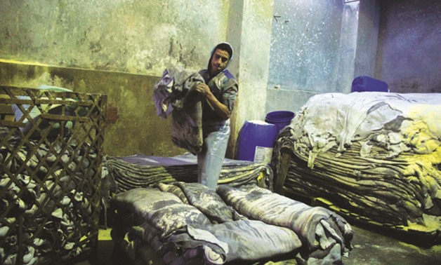 A worker at a tannery in Sour Magra El-Oyoun Street in the heart of Old Cairo - by Abdelrhman Mohamed - Egypt Today