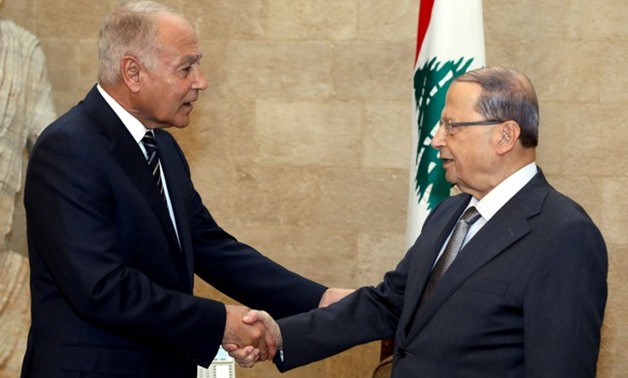 Lebanon's President Michel Aoun shakes hands with Arab League Secretary-General Ahmed Aboul Gheit at the presidential palace in Baabda - REUTERS
