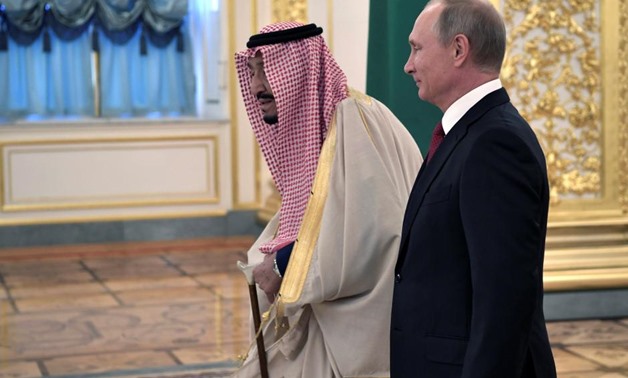 Russian President Vladimir Putin (R) and Saudi Arabia's King Salman walk before their meeting in the Kremlin in Moscow, Russia October 5, 2017.
