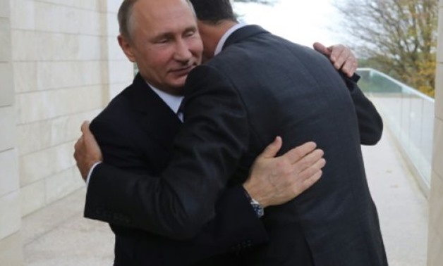 © SPUTNIK/AFP/File | Russia's President Vladimir Putin embraces his Syrian counterpart Bashar al-Assad in Sochi on November 20