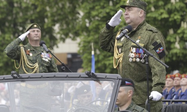  Plotnitsky, leader of self-proclaimed Lugansk People's Republic, salutes during Victory Day military parade in Luhansk - REUTERS