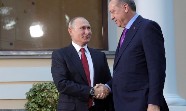 Presidents Tayyip Erdogan of Turkey and Vladimir Putin of Russia shake hands before a three-way summit between the leaders of Russia, Iran and Turkey in Sochi - REUTERS
