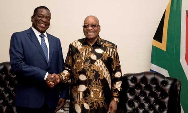 South African President Jacob Zuma shakes hands with Zimbabwe's former vice president Emmerson Mnangagwa in Pretoria - REUTERS