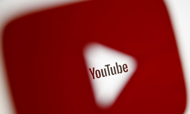 A 3D-printed YouTube icon is seen in front of a displayed YouTube logo in this illustration taken October 25, 2017. REUTERS/Dado Ruvic/Ilustration
