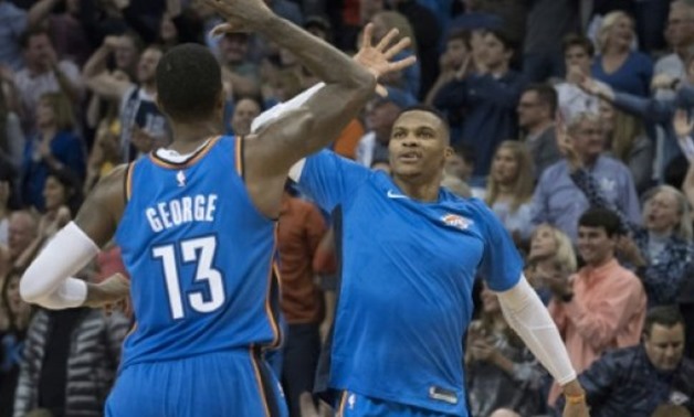  Paul George and Russell Westbrook of the Oklahoma City Thunder celebrate during the second half of their NBA game against the Golden State Warriors, at the Chesapeake Energy Arena in Oklahoma City, on November 22, 2017