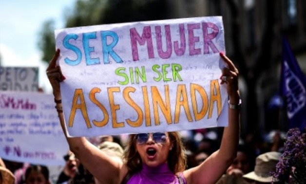 © AFP/File / by Juan José Rodríguez | A woman in Mexico, one of the most dangerous countries for women according to the UN, protests in September 2017 with a sign reading: 'To be a woman without being murdered'
