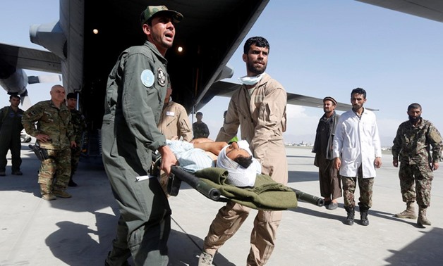 Afghan Air Force medical personnel carry an injured member of the Afghan security forces off a C-130 military transport plane in Kabul, Afghanistan July 9, 2017. (Reuters)
