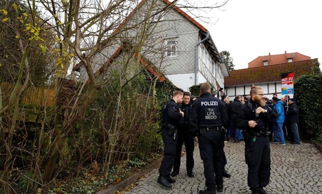 Police stands in front of supporters of the anti-immigrant Alternative for Germany (AFD), blocking the entrance to a property which was used by a German political art group to built a pared-down version of Berlin's Holocaust memorial next to the home of A