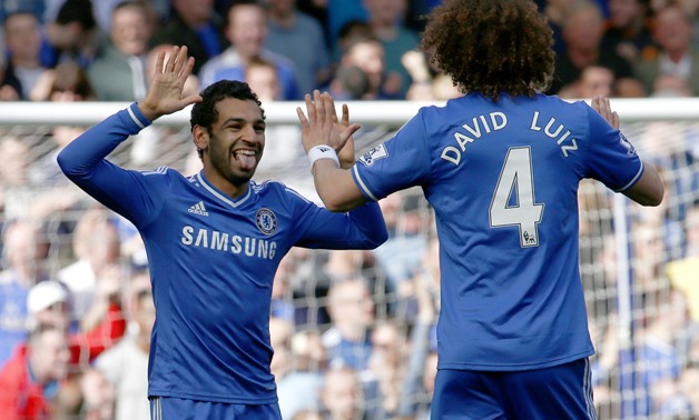 Chelsea's Mohamed Salah (left) celebrates with team mate David Luiz after scoring a goal for Chelsea against Arsenal during their English Premier League match at Stamford Bridge in London, March 22, 2014 - Reuters
