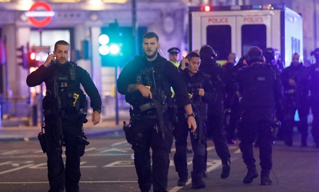 Armed police officers walk along Oxford Street, London - Reuters
