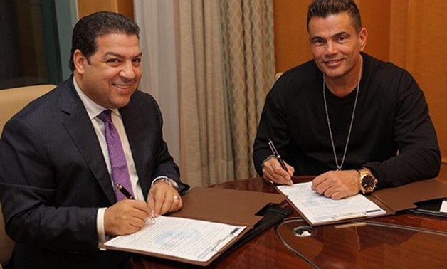 Amr Diab signing a contract with Al-Hayat Channel chairman Sherif Khaled, Wednesday, Nov. 22, 2017 – Photo courtesy of Amr Diab’s official Instagram account