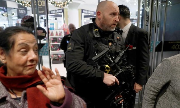 Armed police officers mix with shoppers in an Oxford Street store, in London, Britain November 24, 2017. REUTERS/Peter Nicholls
