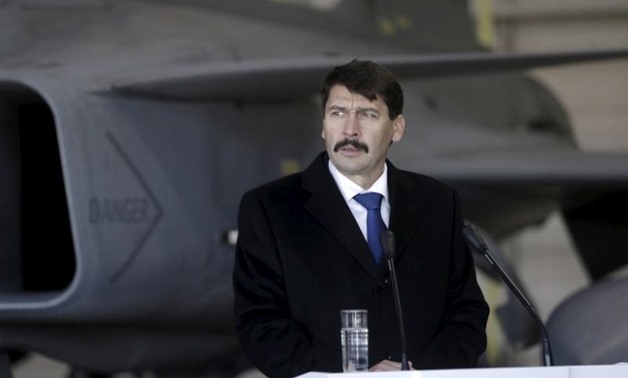 Hungarian President Janos Ader speaks to the media in front of a Hungarian Air Force Gripen JAS-39 fighter as he visits NATO's air policing mission over the Baltics in Siauliai Air Base, Lithuania, December 8, 2015. REUTERS/Ints Kalnins

