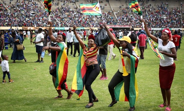 Locals celebrate after the swearing in of Zimbabwe's new president Emmerson Mnangagwa in Harare, Zimbabwe, November 24, 2017. REUTERS/Siphiwe Sibeko

