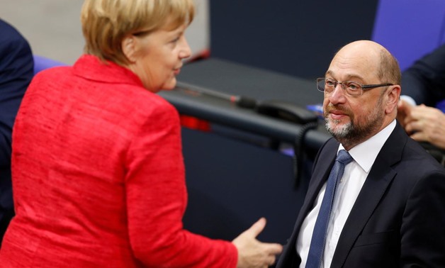 German Chancellor Angela Merkel speaks with Social Democratic Party (SPD) leader Martin Schulz as they attend a meeting of the Bundestag in Berlin, Germany, November 21, 2017. REUTERS/Axel Schmidt