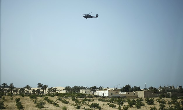 A military helicopter conducts an aerial patrol above Sheikh Zuwayed city, northern Sinai, May 25, 2015- Reuters