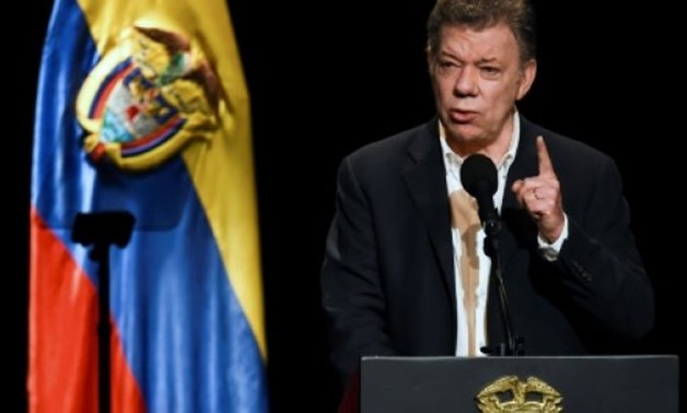 © AFP | Colombian President Juan Manuel Santos and FARC leader Rodrigo Londono returned Friday to the same Bogota theater where they signed the deal a year ago to end Latin America's longest war
