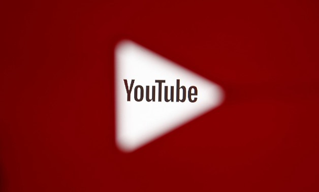 A 3D-printed YouTube icon is seen in front of a displayed YouTube logo in this illustration taken October 25, 2017. REUTERS/Dado Ruvic/Ilustration