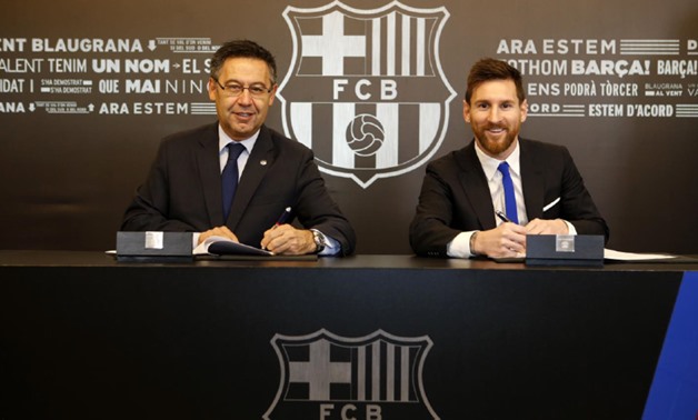 Barcelona`s president Josep Maria Bartomeu (L) with Lionel Messi (R) signing his new contract - Courtesy of FC Barcelona official website