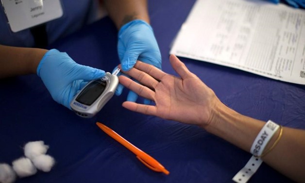 A person receives a test for diabetes during Care Harbor LA free medical clinic in Los Angeles, California September 11, 2014. REUTERS/Mario Anzuoni