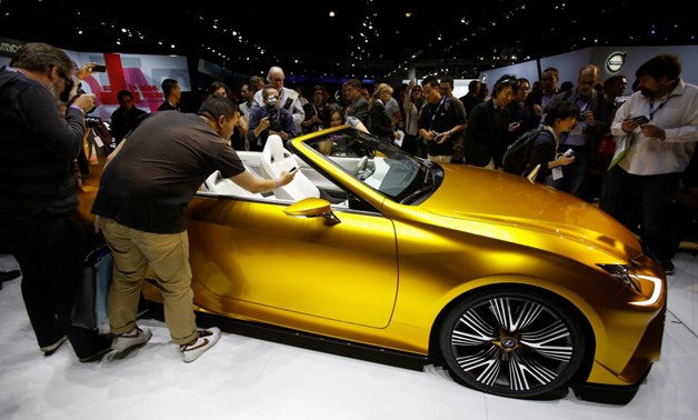 People look at a Lexus LF-C2 concept vehicle on display during the model's world debut at the Los Angeles Auto Show in Los Angeles, California November 19, 2014. REUTERS/Mario Anzuoni