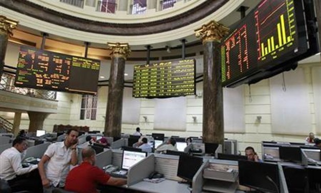 REUTERS-Traders work at the Egyptian stock exchange in Cairo