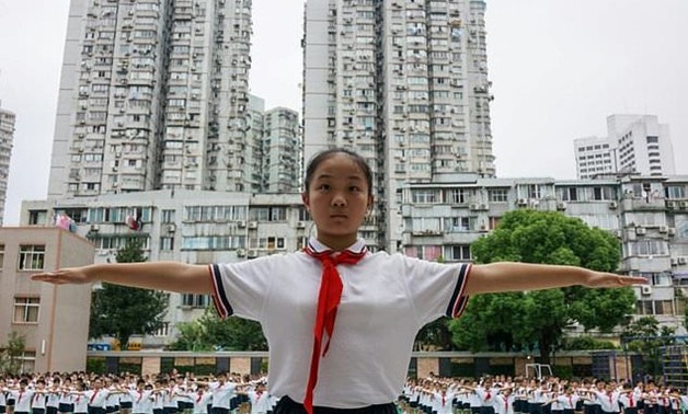 Students take part in a physical training session at their school in Shanghai - AFP
