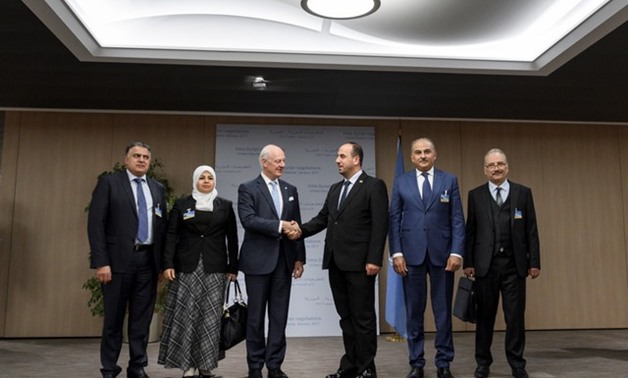 UN Special Envoy for Syria De Mistura greets head of SNC Al-Hariri and delegates from the newly-unified Syrian opposition on the opening of a new round of Syria's peace talks at the United Naitons Office in Geneva - REUTERS
