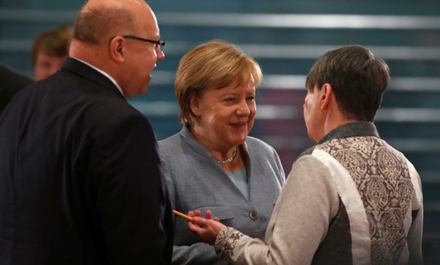 File- Acting German Chancellor Angela Merkel talks with German Environment Minister Barbara Hendricks and Head of Federal Chancellery Peter Altmaier before the meeting with mayors at Chancellery in Berlin, Germany, November 28, 2017. REUTERS/Hannibal Hans