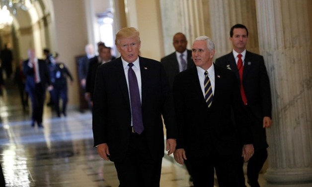 U.S. President Donald Trump and Vice President Mike Pence depart the U.S. Capitol after meeting with House Republicans ahead of their vote on the "Tax Cuts and Jobs Act" in Washington, U.S., November 16, 2017. REUTERS/Aaron