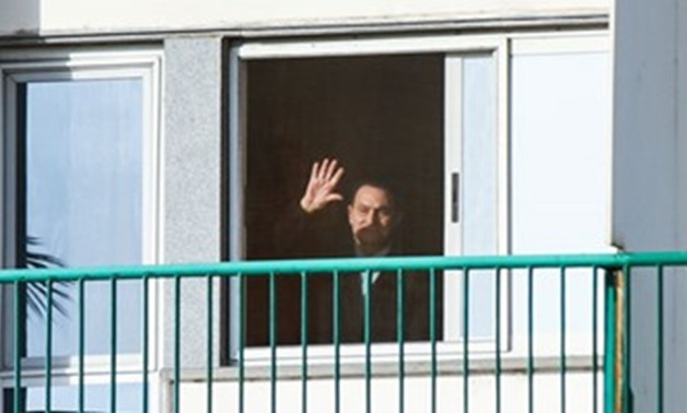 File: Former President Hosni Mubarak waving from the window of his hospital