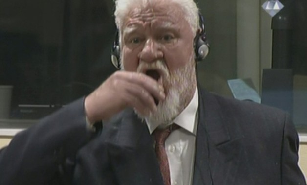 A wartime commander of Bosnian Croat forces, Slobodan Praljak, is seen during a hearing at the U.N. war crimes tribunal in the Hague - REUTERS