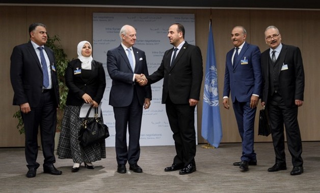 UN Special Envoy for Syria De Mistura greets head of SNC Al-Hariri and delegates from the newly-unified Syrian opposition on the opening of a new round of Syria's peace talks at the United Naitons Office in Geneva - REUTERS
