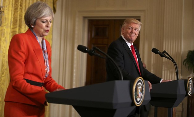 British Prime Minister Theresa May speaks as U.S. President Donald Trump looks on during their joint news conference at the White House in Washington, U.S., January 27, 2017. REUTERS/Carlos Barria