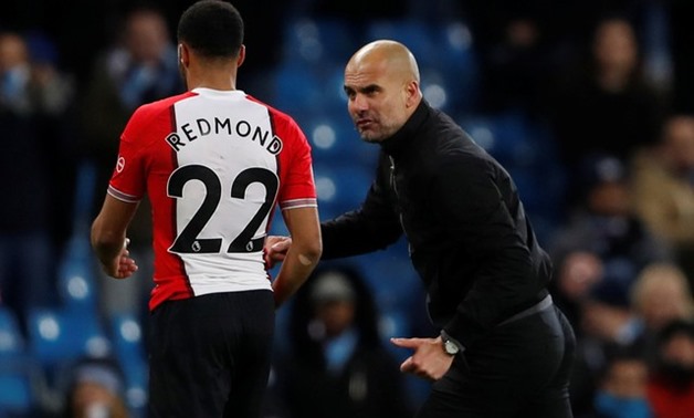 Premier League - Manchester City vs Southampton - Etihad Stadium, Manchester, Britain - November 29, 2017 Manchester City manager Pep Guardiola talks to Southampton's Nathan Redmond, who looks dejected, at the end of the match Action Images - Reuters