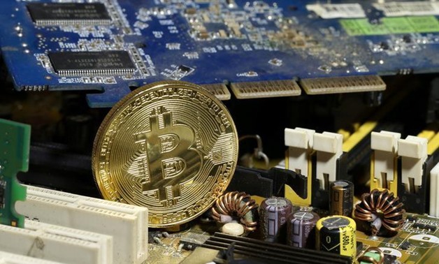 A copy of bitcoin standing on PC motherboard is seen in this illustration picture, October 26, 2017. REUTERS/Dado Ruvic