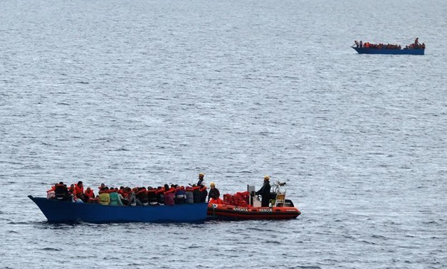 Migrants on wooden boats in the Mediterranean Sea off the coast of Libyam - Reuters Photo